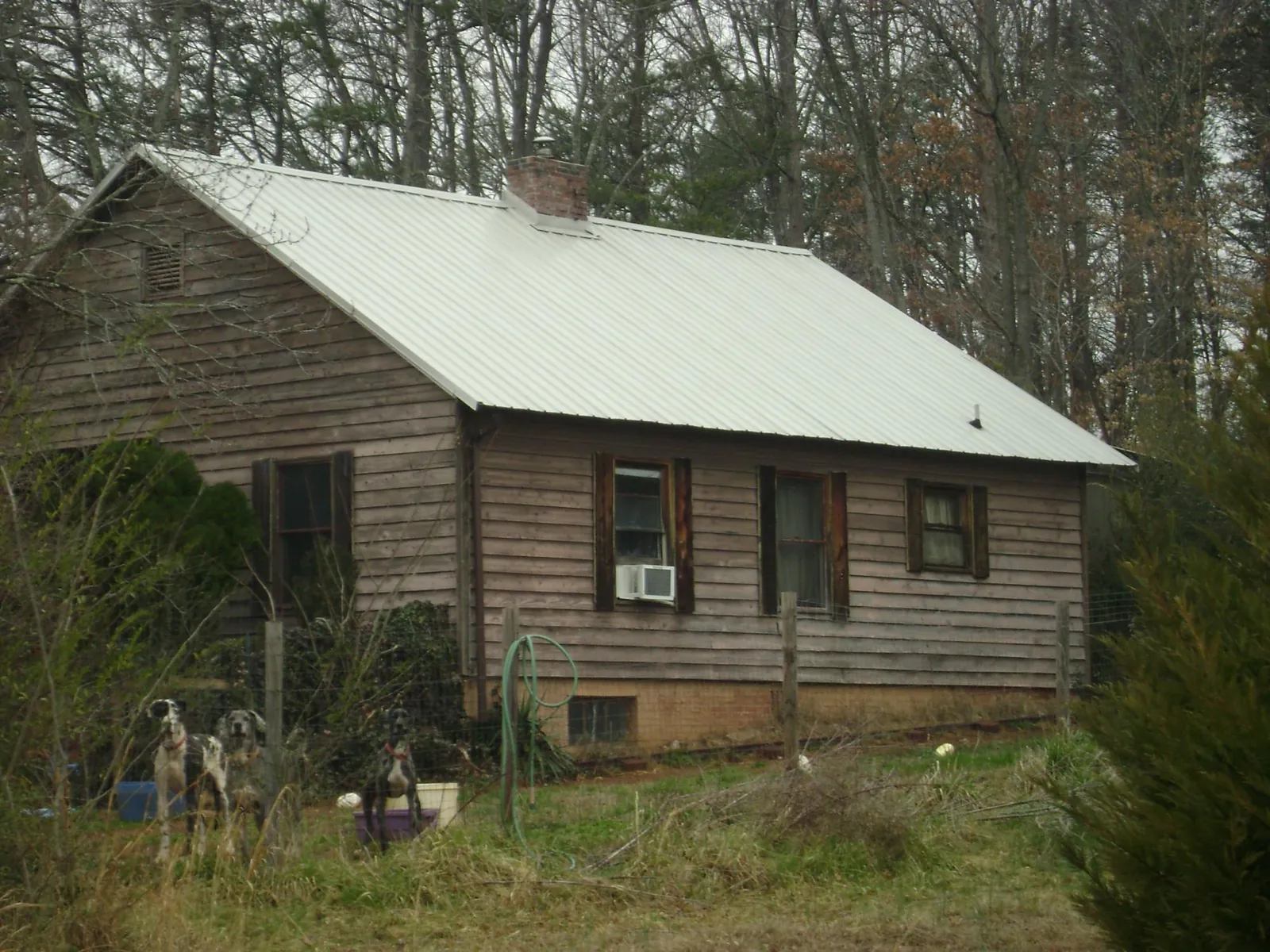 White metal roof on an old wood sided farmhouse, from a Metal Roof Installation job in Ramah